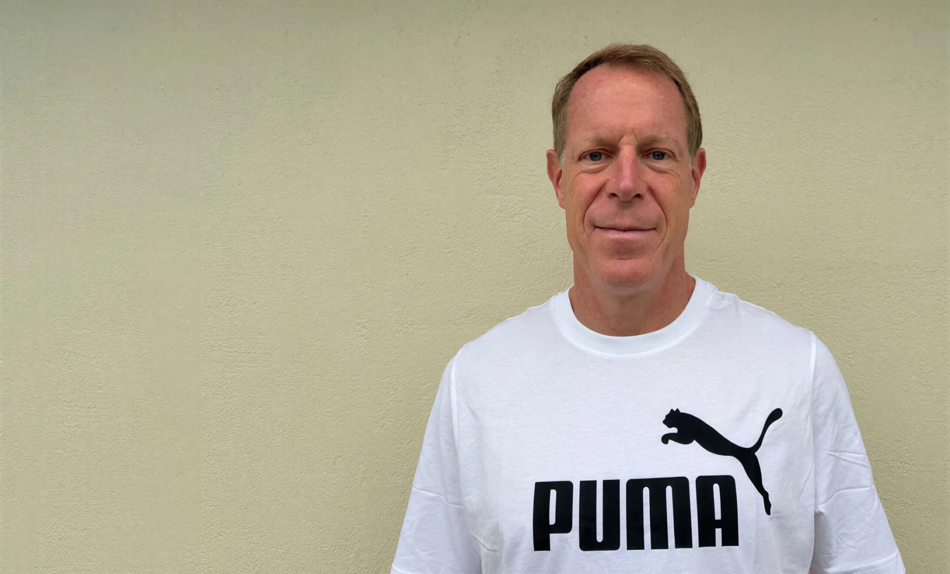 Arne Arens wearing a white PUMA T-shirt in the portrait supplied with his appointment announcement.