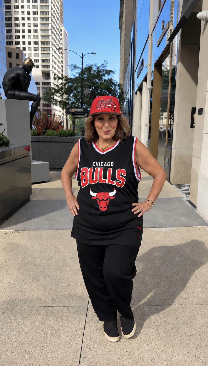 Laura Geller wearing a Chicago Bulls cap and jersey outdoors.